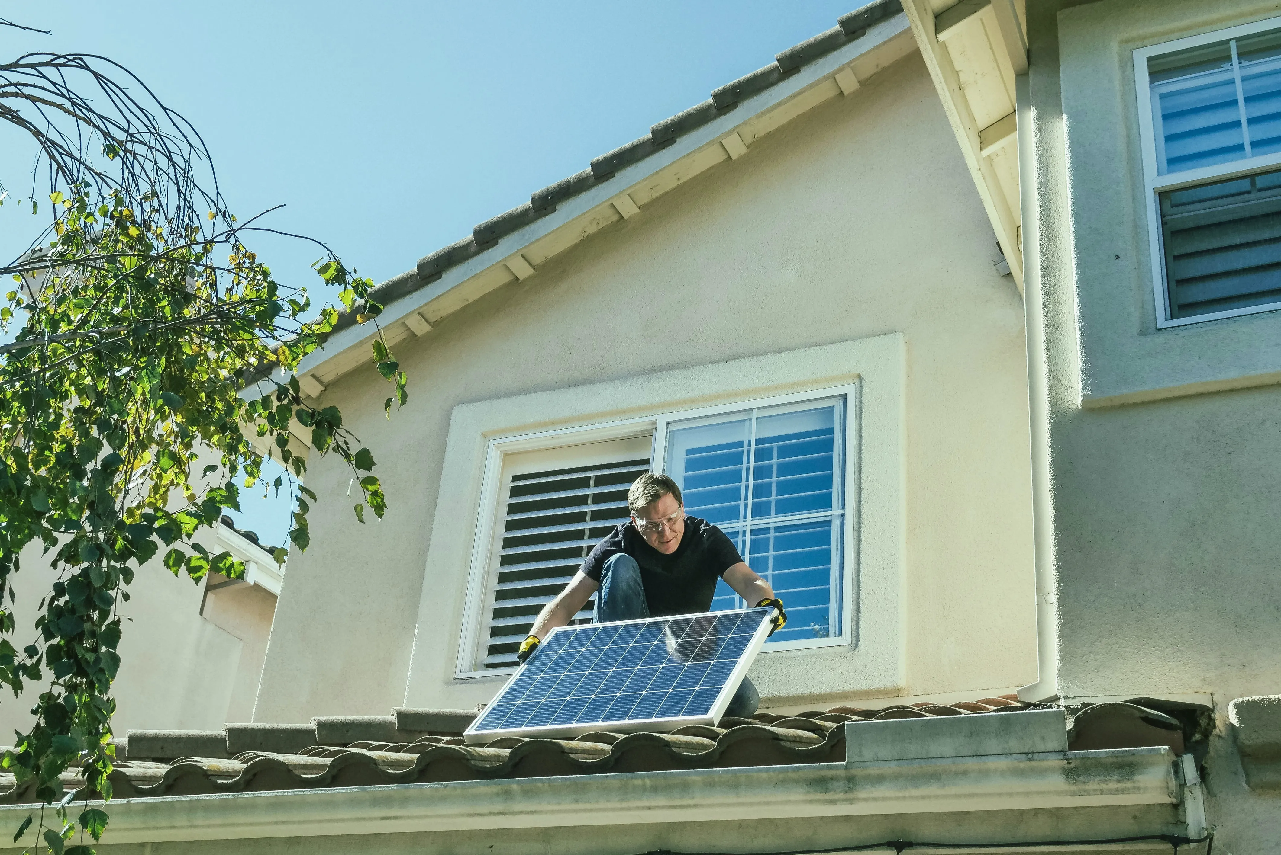 Solar panel installation in progress on a large roof